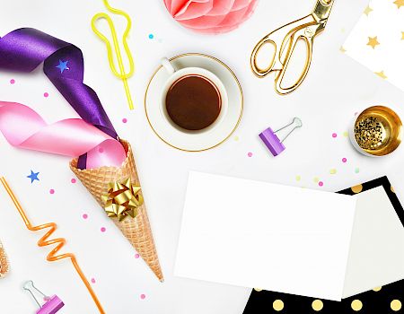 The image shows ribbons, a cup of coffee, scissors, an ice cream cone with a bow, binder clips, confetti, an envelope, and decorative papers ending the sentence.
